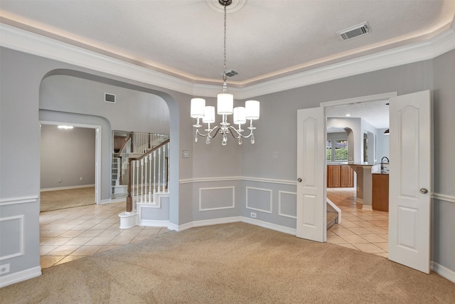 15510 Marble Canyon Way, Houston, TX 77044 - unfurnished dining area featuring arched walkways, light tile patterned flooring, light colored carpet, and a raised ceiling