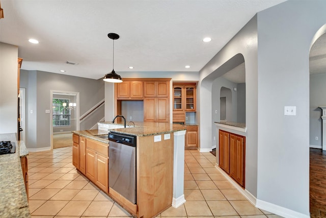 15510 Marble Canyon Way, Houston, TX 77044 - kitchen featuring stainless steel dishwasher, an island with sink, light tile patterned floors, glass insert cabinets, and recessed lighting