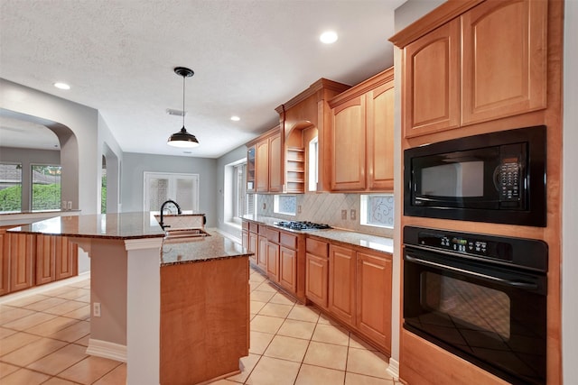 15510 Marble Canyon Way, Houston, TX 77044 - kitchen with black appliances, light tile patterned floors, dark stone counters, decorative backsplash, and recessed lighting