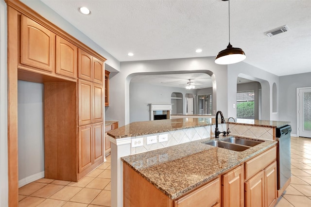 15510 Marble Canyon Way, Houston, TX 77044 - kitchen with light tile patterned flooring, arched walkways, stainless steel dishwasher, light stone counters, and a textured ceiling