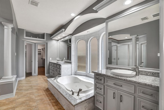 15510 Marble Canyon Way, Houston, TX 77044 - bathroom with decorative columns, a stall shower, vanity, a jetted tub, and a walk in closet