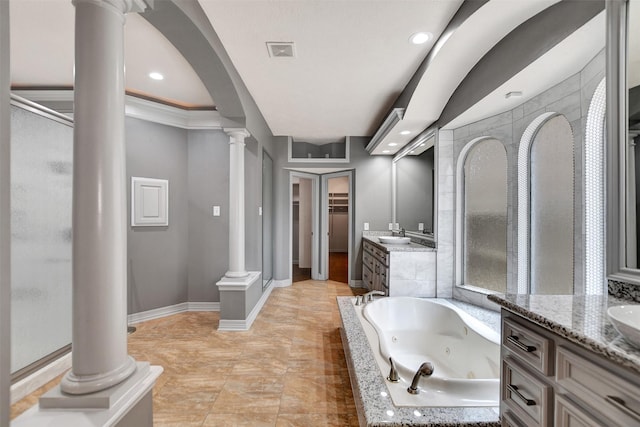 15510 Marble Canyon Way, Houston, TX 77044 - bathroom with ornate columns, two vanities, a shower stall, a tub with jets, and recessed lighting