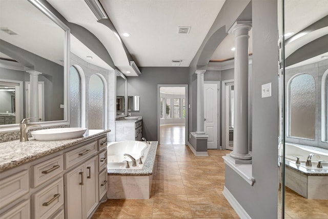 15510 Marble Canyon Way, Houston, TX 77044 - full bath featuring decorative columns, two vanities, and a whirlpool tub