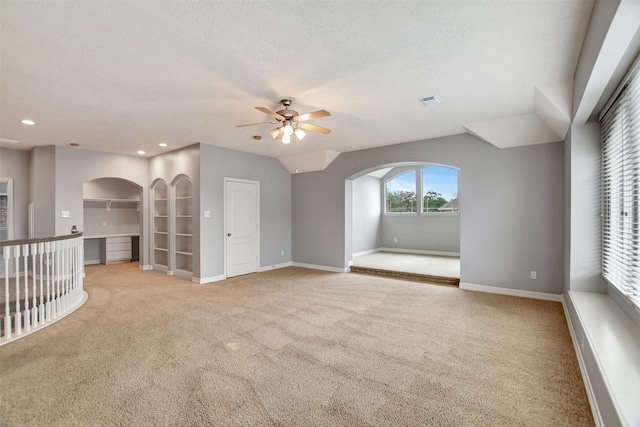 15510 Marble Canyon Way, Houston, TX 77044 - unfurnished living room featuring arched walkways, light carpet, a ceiling fan, a textured ceiling, and recessed lighting