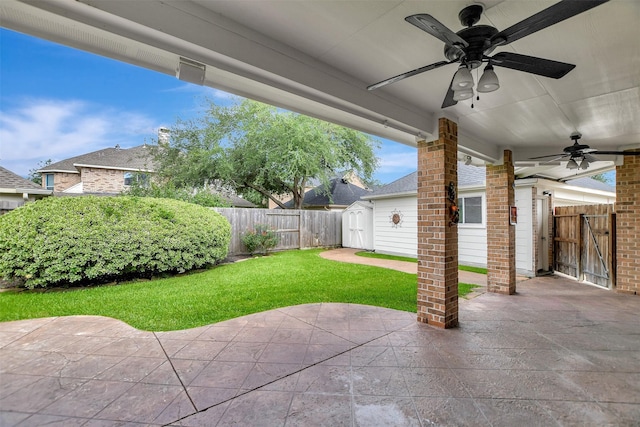 15510 Marble Canyon Way, Houston, TX 77044 - fenced backyard with a ceiling fan, a patio area, and a storage unit