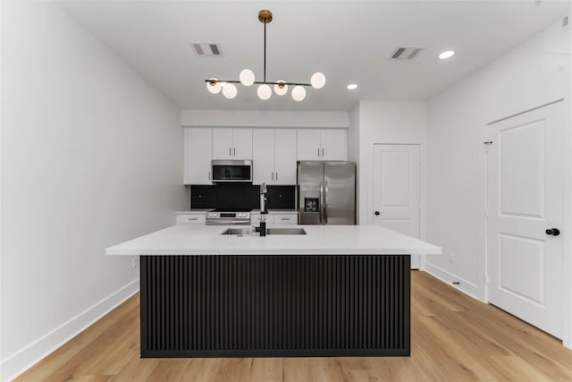 3327 Cornell St Unit A B, Houston, TX 77022 - kitchen with appliances with stainless steel finishes, white cabinets, light wood-style flooring, light countertops, and recessed lighting