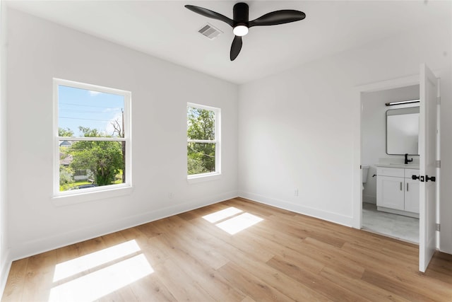 3327 Cornell St Unit A B, Houston, TX 77022 - unfurnished bedroom featuring light wood-type flooring, ensuite bathroom, and ceiling fan