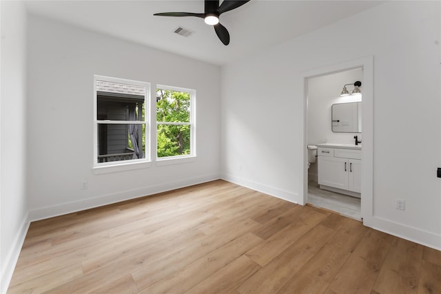 3327 Cornell St Unit A B, Houston, TX 77022 - unfurnished bedroom featuring light wood finished floors, ensuite bath, and ceiling fan