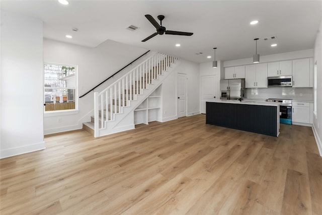 3327 Cornell St Unit A B, Houston, TX 77022 - kitchen featuring stainless steel appliances, ceiling fan, light wood finished floors, light countertops, and recessed lighting
