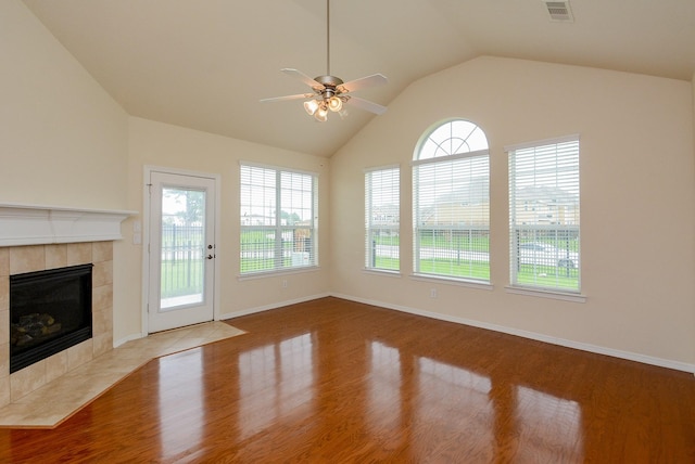 18702 Cypress Loch Dr, Spring, TX 77379 - unfurnished living room with wood finished floors, ceiling fan, a tile fireplace, and lofted ceiling