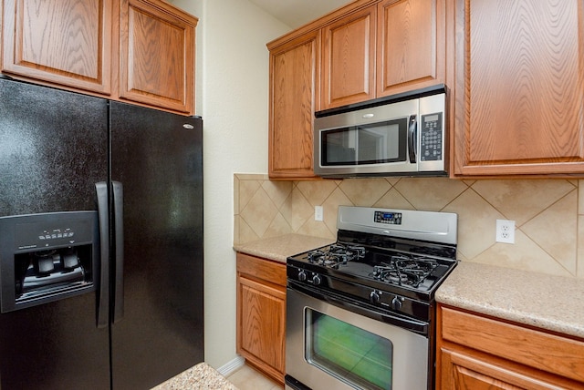 18702 Cypress Loch Dr, Spring, TX 77379 - kitchen with stainless steel appliances, light countertops, and decorative backsplash