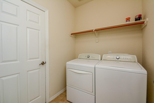 18702 Cypress Loch Dr, Spring, TX 77379 - laundry room with washer and dryer and light tile patterned floors