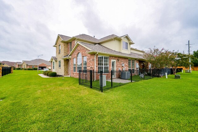 18702 Cypress Loch Dr, Spring, TX 77379 - rear view of house with brick siding, a shingled roof, and a patio area