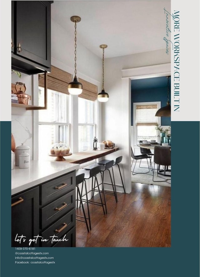 0000 Marina Blvd, Galveston, TX 77554 - kitchen with healthy amount of natural light, dark wood-type flooring, light countertops, and decorative light fixtures