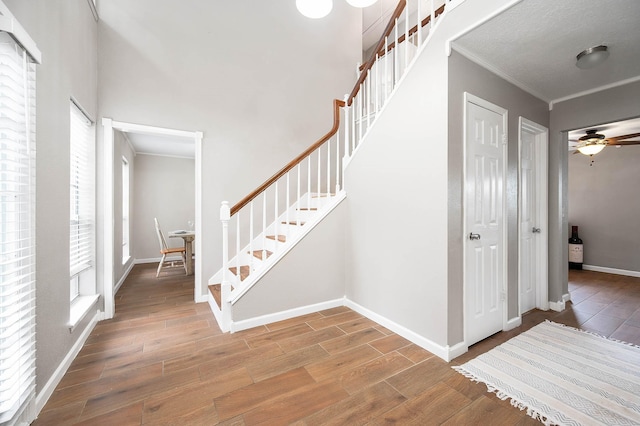 17203 Kettle Creek Dr, Spring, TX 77379 - stairs featuring ornamental molding, wood finished floors, and a ceiling fan