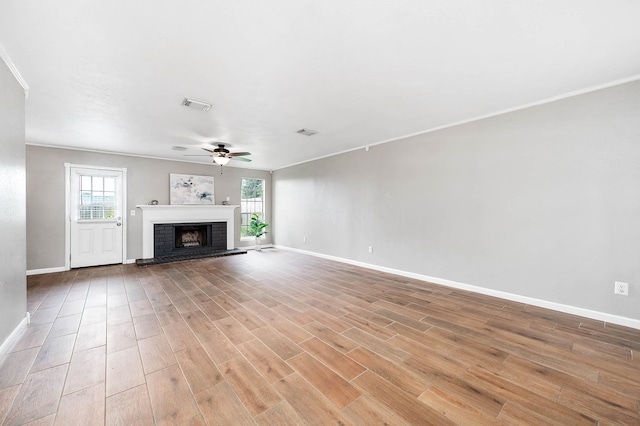 17203 Kettle Creek Dr, Spring, TX 77379 - unfurnished living room with light wood-style floors, ceiling fan, plenty of natural light, and ornamental molding