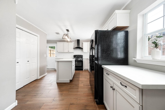 17203 Kettle Creek Dr, Spring, TX 77379 - kitchen featuring black appliances, wall chimney exhaust hood, a kitchen island, wood finished floors, and white cabinetry