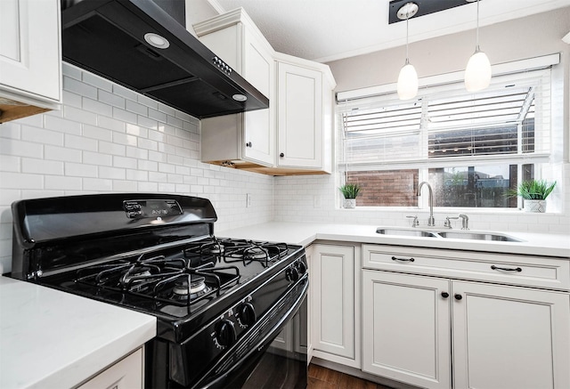 17203 Kettle Creek Dr, Spring, TX 77379 - kitchen featuring black gas range, extractor fan, light countertops, white cabinets, and decorative backsplash