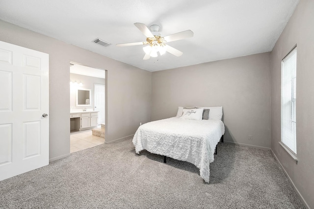 17203 Kettle Creek Dr, Spring, TX 77379 - bedroom with light carpet, ensuite bathroom, and ceiling fan