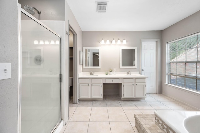 17203 Kettle Creek Dr, Spring, TX 77379 - bathroom featuring a shower stall, double vanity, tile patterned floors, and a relaxing tiled tub