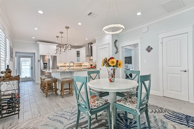 6 Caravelle Ct, Galveston, TX 77554 - dining area with wood tiled floors, recessed lighting, and ornamental molding