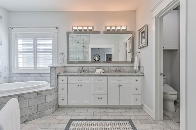 6 Caravelle Ct, Galveston, TX 77554 - full bath with double vanity, a garden tub, a tile shower, and marble look tiles