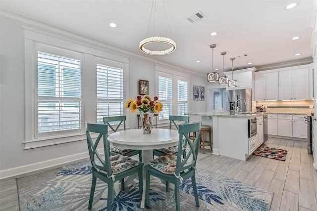 6 Caravelle Ct, Galveston, TX 77554 - dining space featuring light wood-type flooring, recessed lighting, and ornamental molding