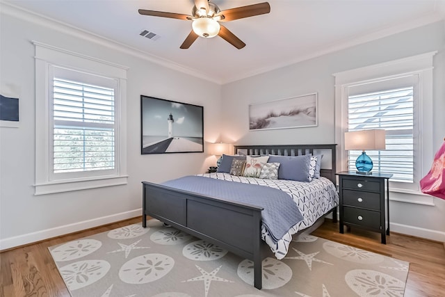 6 Caravelle Ct, Galveston, TX 77554 - bedroom with wood finished floors, multiple windows, crown molding, and a ceiling fan