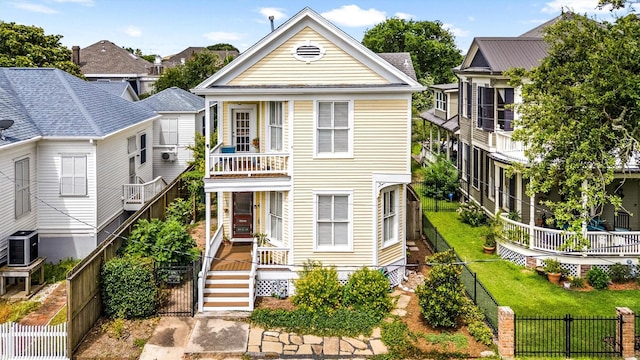 1611 34th St, Galveston, TX 77550 - view of front facade with a fenced backyard, a gate, and a balcony