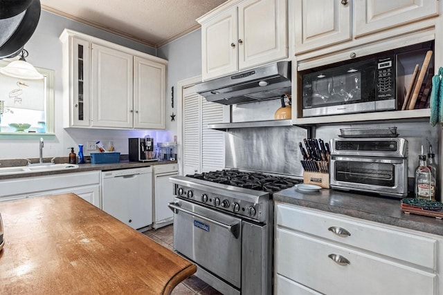 1611 34th St, Galveston, TX 77550 - kitchen with white dishwasher, stainless steel stove, under cabinet range hood, black microwave, and ornamental molding