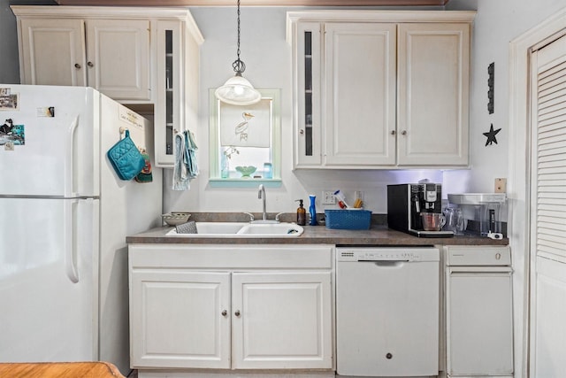 1611 34th St, Galveston, TX 77550 - kitchen featuring white appliances, glass insert cabinets, pendant lighting, dark countertops, and white cabinets