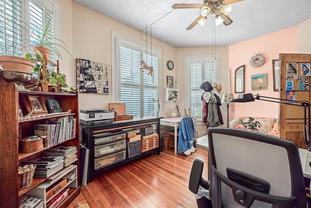 1611 34th St, Galveston, TX 77550 - home office with ceiling fan, a textured ceiling, and wood finished floors