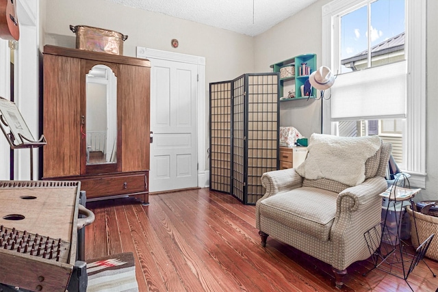 1611 34th St, Galveston, TX 77550 - sitting room with plenty of natural light, wood finished floors, and a textured ceiling