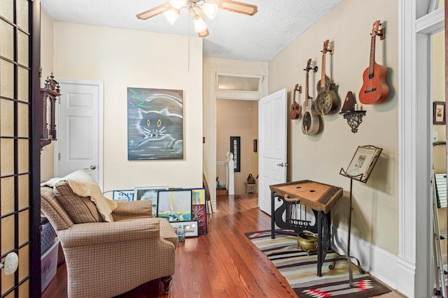 1611 34th St, Galveston, TX 77550 - sitting room with wood finished floors, ceiling fan, and a textured ceiling
