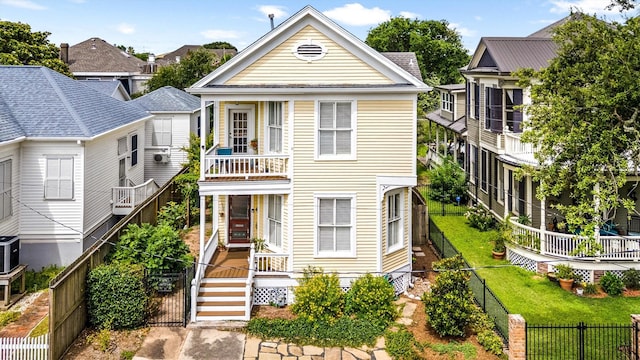1611 34th St, Galveston, TX 77550 - view of front of property with a fenced backyard and a balcony