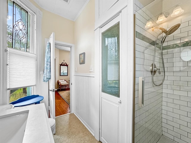1611 34th St, Galveston, TX 77550 - full bath featuring a shower stall, healthy amount of natural light, a wainscoted wall, crown molding, and vanity