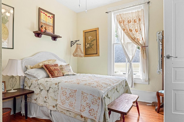 1611 34th St, Galveston, TX 77550 - bedroom with multiple windows and wood finished floors