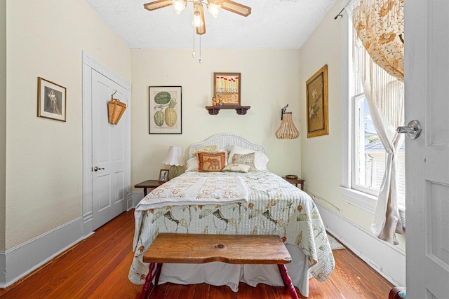 1611 34th St, Galveston, TX 77550 - bedroom featuring a textured ceiling, wood finished floors, and ceiling fan