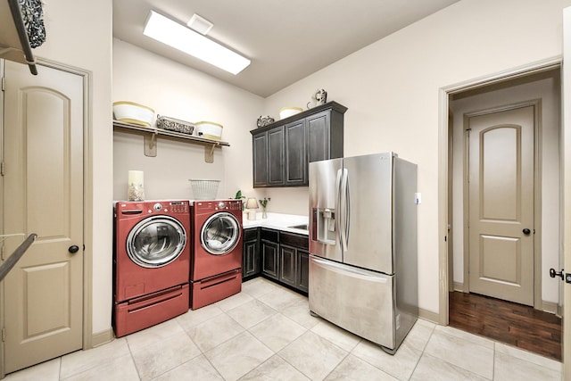 13810 Lake Prt, Cypress, TX 77429 - laundry room featuring washer and dryer, cabinet space, and light tile patterned flooring