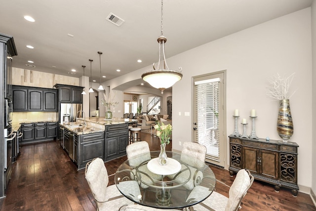 13810 Lake Prt, Cypress, TX 77429 - dining space featuring arched walkways, dark wood-style floors, and recessed lighting