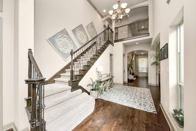13810 Lake Prt, Cypress, TX 77429 - foyer featuring a high ceiling, arched walkways, wood finished floors, a chandelier, and stairs