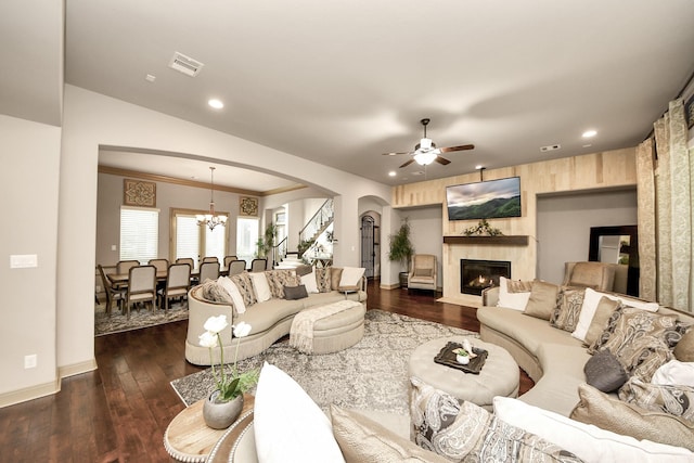 13810 Lake Prt, Cypress, TX 77429 - living room with arched walkways, a chandelier, a fireplace with flush hearth, a ceiling fan, and dark wood-style floors