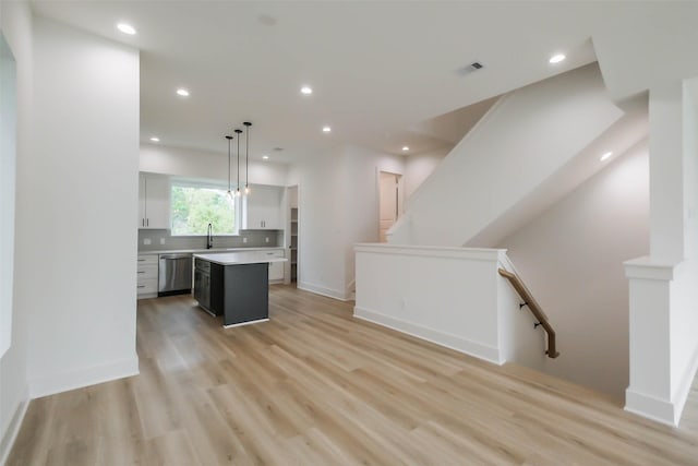 5703C Balbo St, Houston, TX 77091 - kitchen featuring dishwasher, a center island, light countertops, light wood-style floors, and recessed lighting