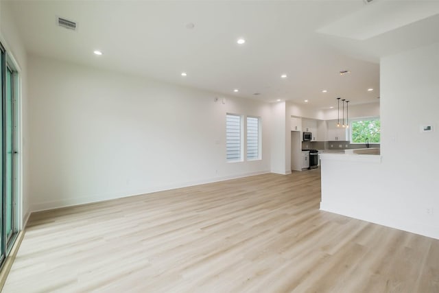 5703C Balbo St, Houston, TX 77091 - unfurnished living room featuring light wood-style floors and recessed lighting