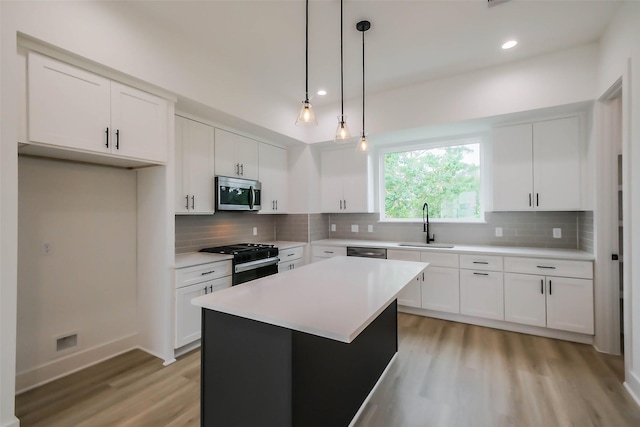 5703C Balbo St, Houston, TX 77091 - kitchen featuring appliances with stainless steel finishes, light wood-style flooring, light countertops, white cabinets, and recessed lighting