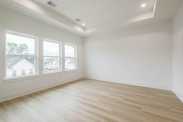 5703C Balbo St, Houston, TX 77091 - spare room with a tray ceiling, light wood-style flooring, and recessed lighting