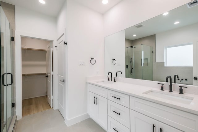 5703C Balbo St, Houston, TX 77091 - full bath with a stall shower, double vanity, a walk in closet, tile patterned floors, and recessed lighting