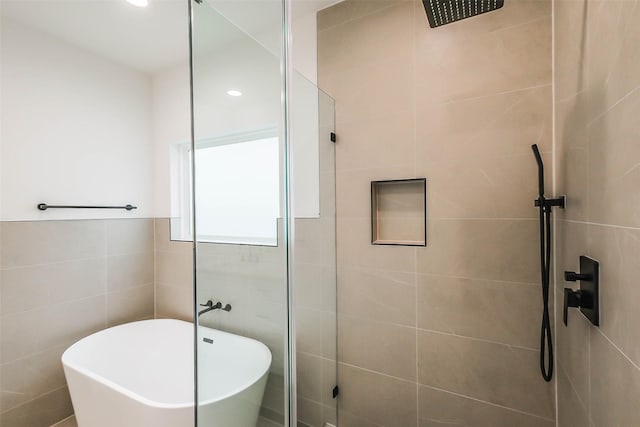 5703C Balbo St, Houston, TX 77091 - full bathroom featuring a tile shower, a soaking tub, tile walls, and recessed lighting