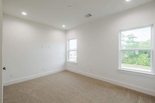 5703C Balbo St, Houston, TX 77091 - empty room with light colored carpet, plenty of natural light, and recessed lighting