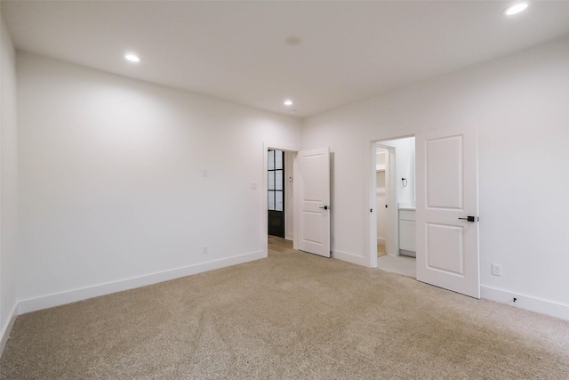 5703C Balbo St, Houston, TX 77091 - unfurnished bedroom featuring light colored carpet, recessed lighting, and ensuite bathroom